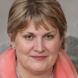 Joyful white adult female with medium  brown hair and blue eyes