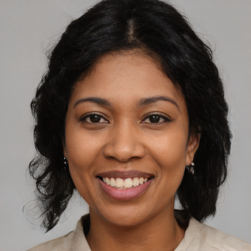 Joyful latino young-adult female with medium  black hair and brown eyes
