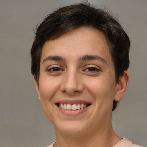 Joyful white young-adult female with short  brown hair and brown eyes