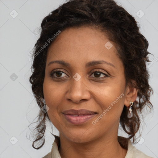 Joyful black adult female with medium  brown hair and brown eyes