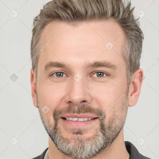 Joyful white adult male with short  brown hair and grey eyes