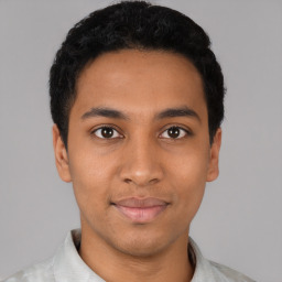 Joyful latino young-adult male with short  black hair and brown eyes