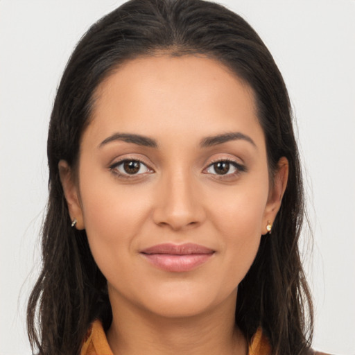 Joyful latino young-adult female with long  brown hair and brown eyes