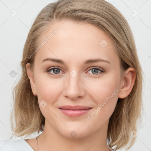 Joyful white young-adult female with medium  brown hair and blue eyes