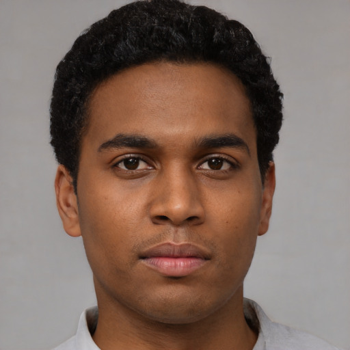 Neutral black young-adult male with short  black hair and brown eyes