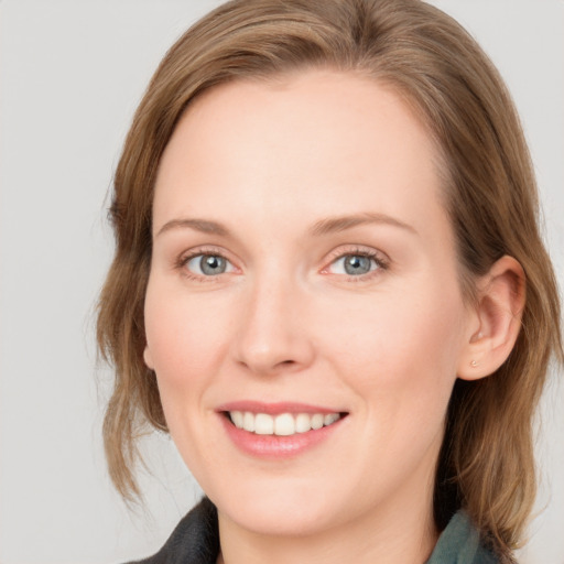 Joyful white young-adult female with medium  brown hair and blue eyes