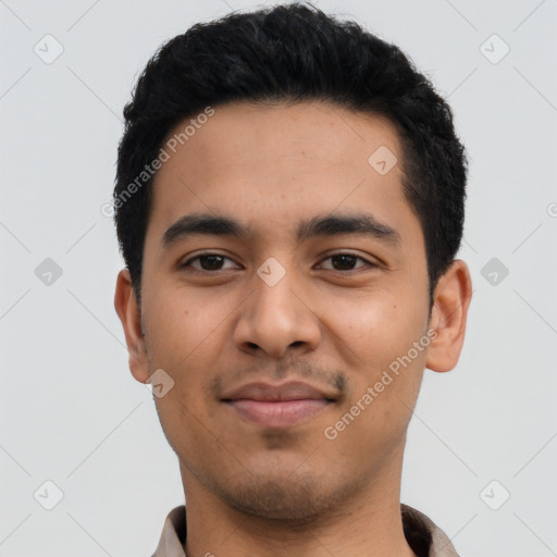 Joyful latino young-adult male with short  black hair and brown eyes