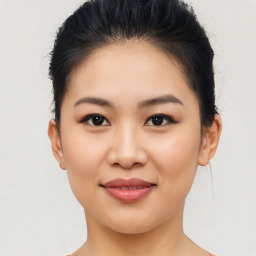 Joyful asian young-adult female with medium  brown hair and brown eyes