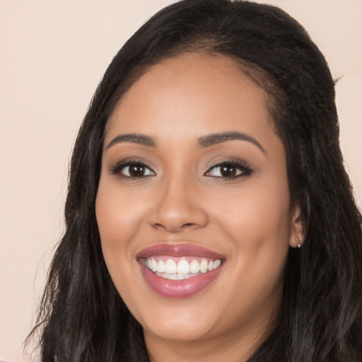 Joyful latino young-adult female with long  black hair and brown eyes