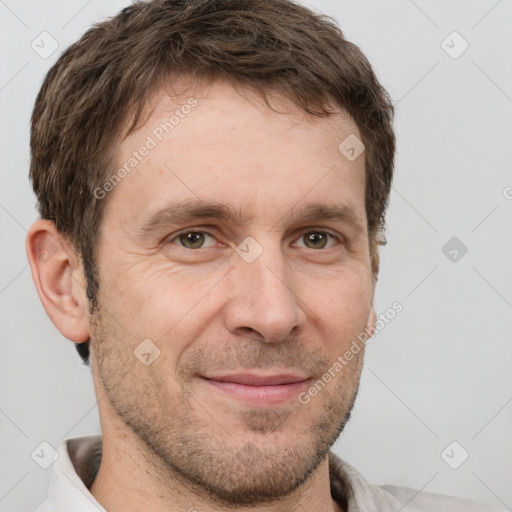 Joyful white adult male with short  brown hair and grey eyes