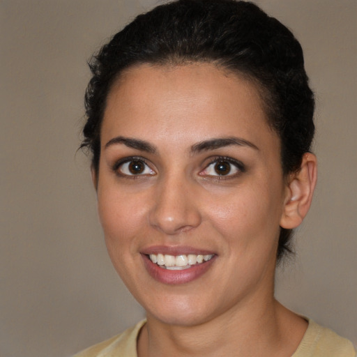 Joyful white young-adult female with short  brown hair and brown eyes