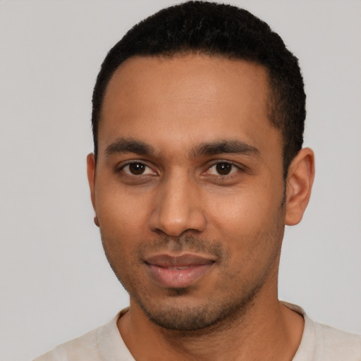 Joyful latino young-adult male with short  black hair and brown eyes