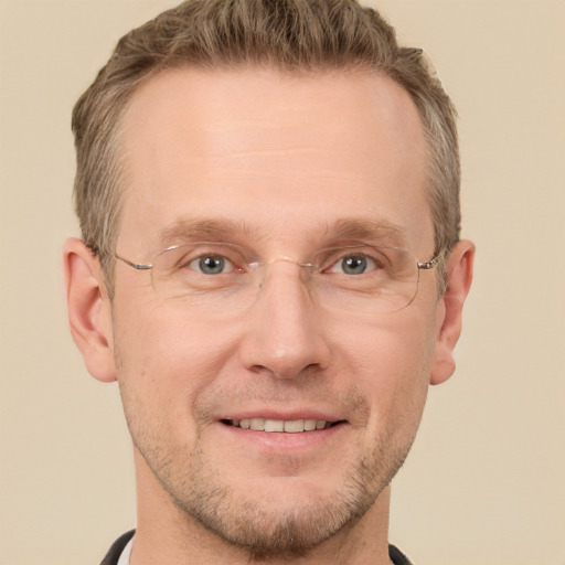 Joyful white adult male with short  brown hair and grey eyes