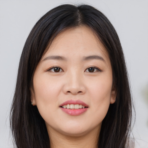 Joyful asian young-adult female with long  brown hair and brown eyes