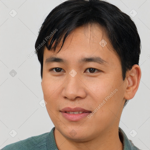 Joyful asian young-adult male with short  black hair and brown eyes