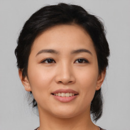 Joyful asian young-adult female with medium  black hair and brown eyes