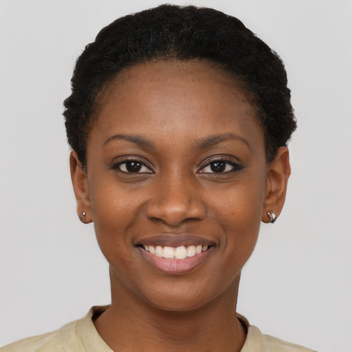 Joyful black young-adult female with short  black hair and brown eyes