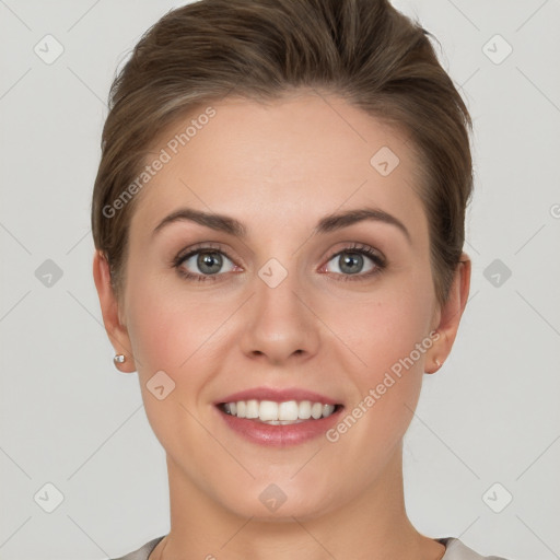 Joyful white young-adult female with short  brown hair and grey eyes