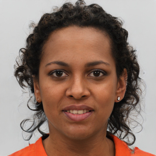 Joyful black young-adult female with medium  brown hair and brown eyes