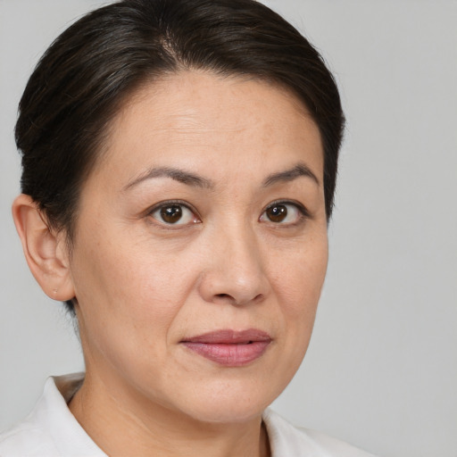 Joyful white adult female with short  brown hair and brown eyes