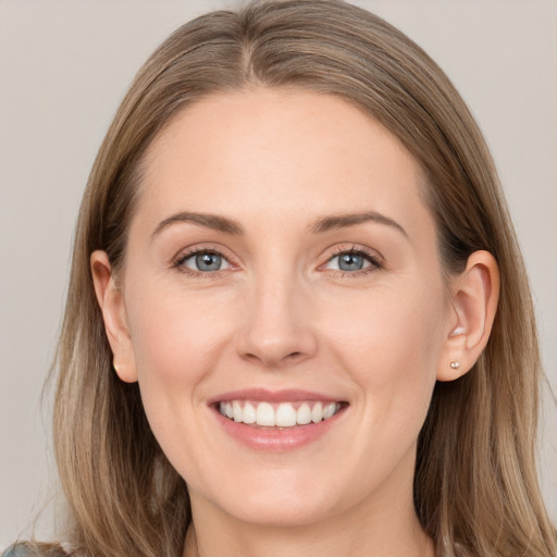 Joyful white young-adult female with long  brown hair and grey eyes