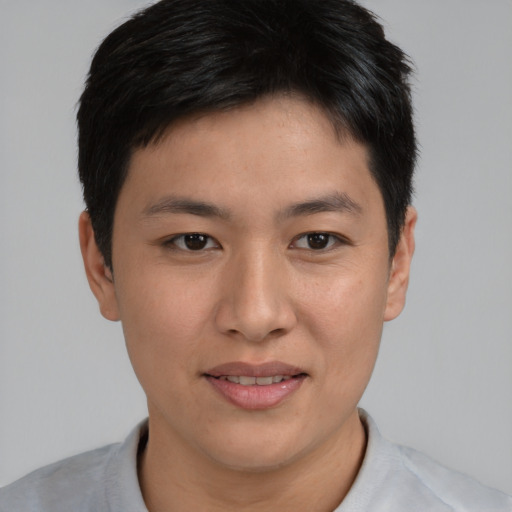 Joyful asian young-adult male with short  brown hair and brown eyes