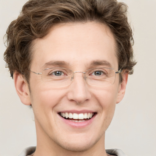 Joyful white adult male with short  brown hair and grey eyes