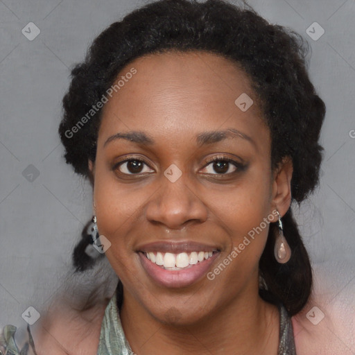 Joyful black adult female with medium  black hair and brown eyes