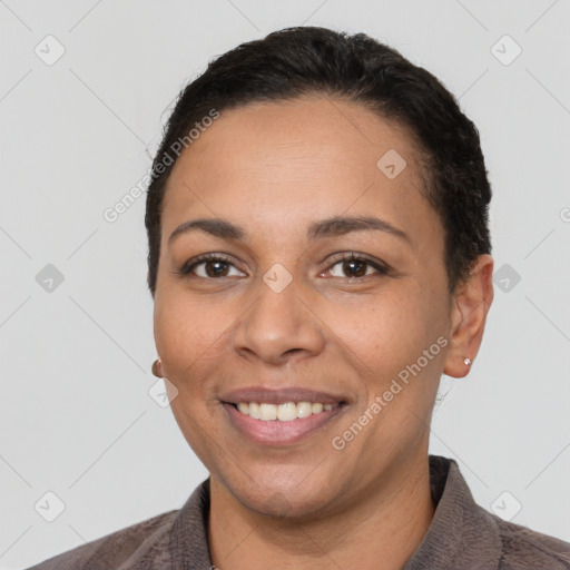 Joyful latino young-adult female with short  black hair and brown eyes