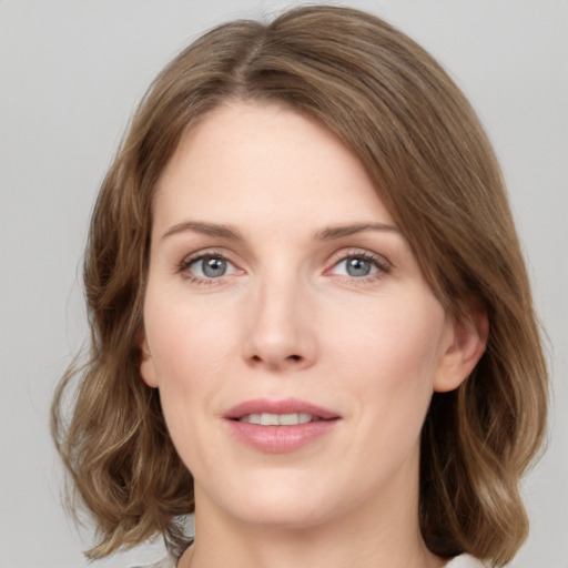 Joyful white young-adult female with medium  brown hair and green eyes