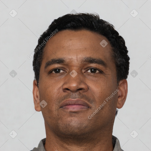 Neutral latino adult male with short  black hair and brown eyes