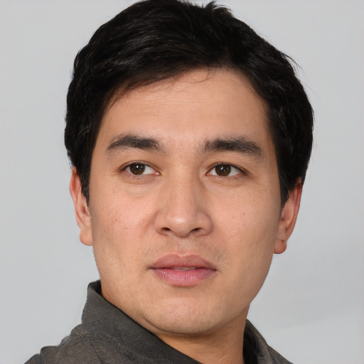 Joyful white young-adult male with short  black hair and brown eyes