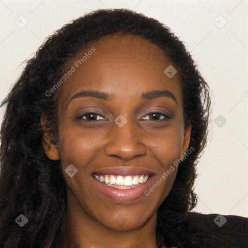 Joyful black young-adult female with long  brown hair and brown eyes