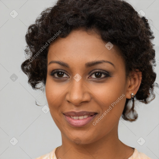 Joyful black young-adult female with medium  brown hair and brown eyes