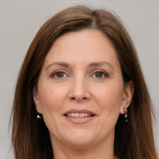 Joyful white adult female with long  brown hair and grey eyes