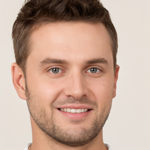 Joyful white young-adult male with short  brown hair and brown eyes