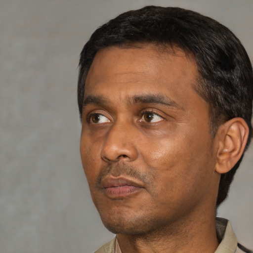 Neutral black adult male with short  black hair and brown eyes