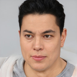 Joyful asian adult male with short  brown hair and brown eyes