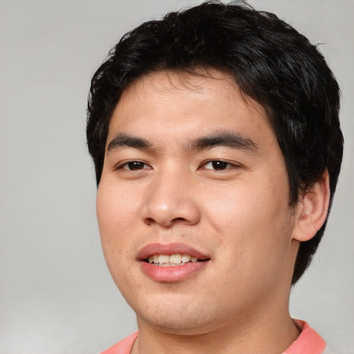Joyful asian young-adult male with short  black hair and brown eyes