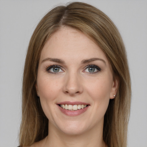 Joyful white young-adult female with long  brown hair and grey eyes