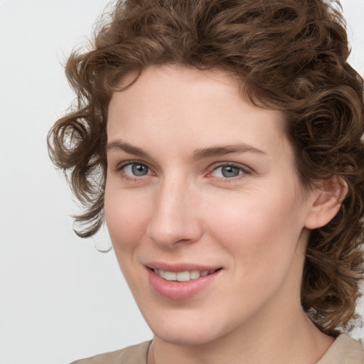 Joyful white young-adult female with medium  brown hair and green eyes