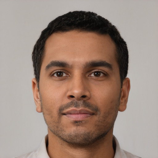 Neutral latino young-adult male with short  black hair and brown eyes