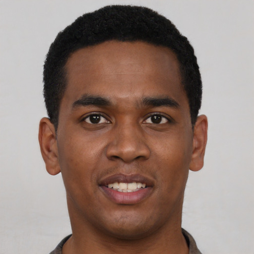 Joyful black young-adult male with short  black hair and brown eyes