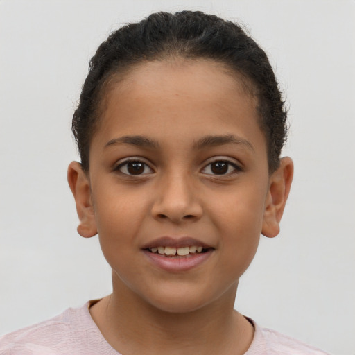 Joyful latino child female with short  brown hair and brown eyes