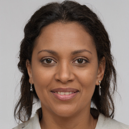 Joyful black adult female with medium  brown hair and brown eyes