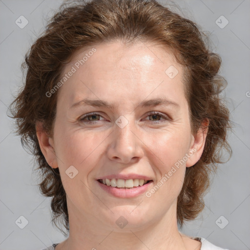 Joyful white adult female with medium  brown hair and blue eyes