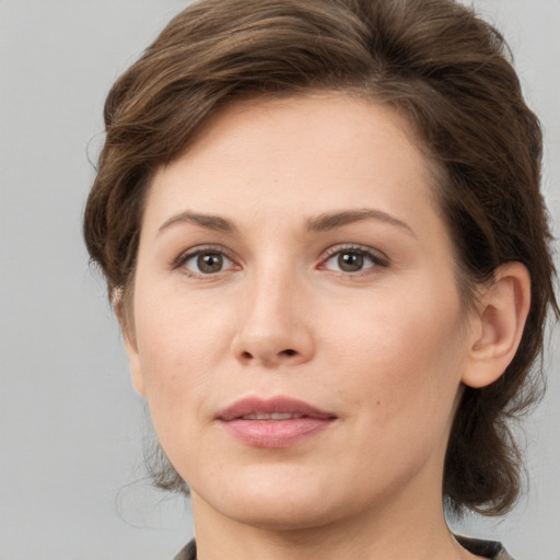 Joyful white young-adult female with medium  brown hair and grey eyes