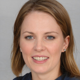 Joyful white young-adult female with medium  brown hair and blue eyes