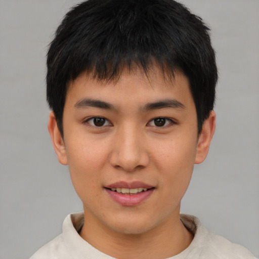 Joyful asian young-adult male with short  brown hair and brown eyes