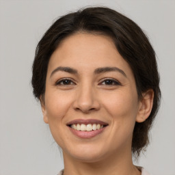 Joyful white young-adult female with medium  brown hair and brown eyes